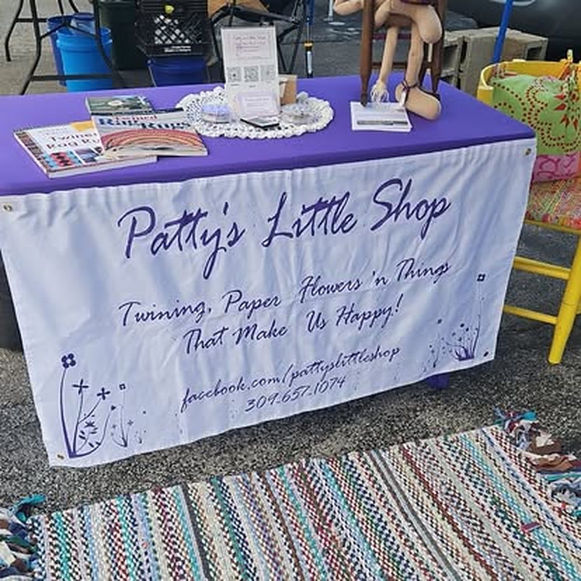 Patty's Little Shop banner on a purple table